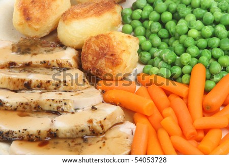 Stuffed chicken breast with roast potatoes, vegetables and gravy.