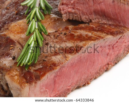 Rare rib-eye steak, sliced open.