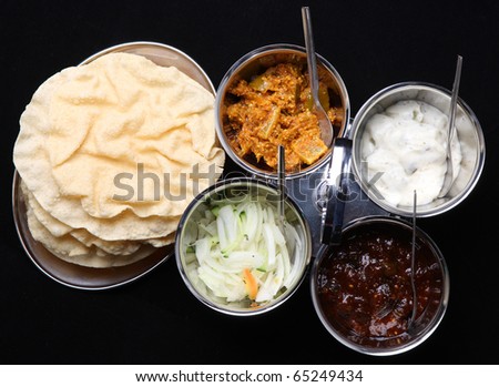Indian poppadums with lime pickle, brinjal pickle, mint raita and onion salad.