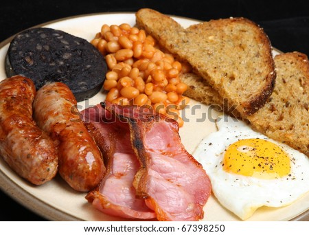Cooked breakfast with black pudding, baked beans and fried bread.