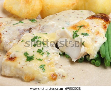 Baked fish with cheese sauce, green beans and roast potatoes.