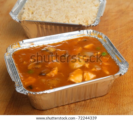 Chinese chicken curry & egg fried rice in takeaway foil containers.