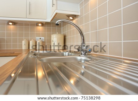 Modern kitchen sink with mixer tap