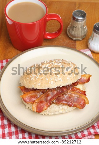 Crispy bacon in a wholemeal roll with a mug of tea.