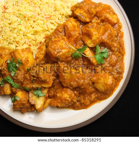 Indian chicken dansak with Bombay aloo potato curry and pilau rice.