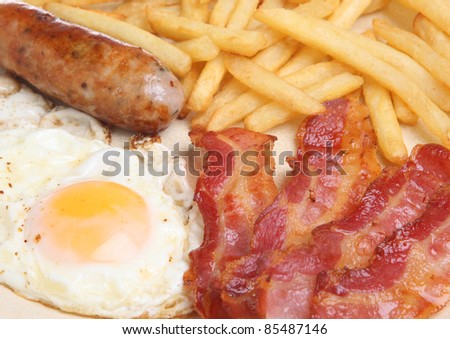 Sausage, bacon, fried egg and fries.