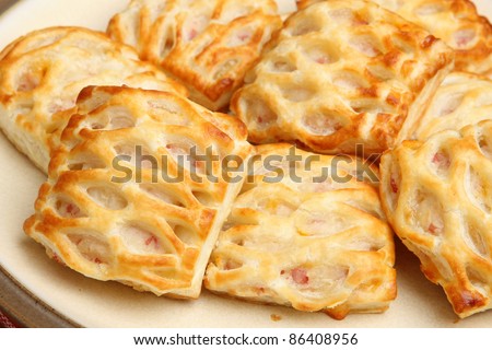 Freshly baked sausage rolls with lattice pastry. Shallow DoF, sharp focus on LH roll.