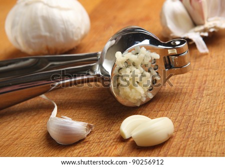 Crushed garlic in a chrome press.
