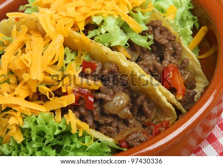 Mexican beef tacos in terracotta serving dish