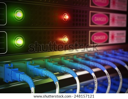 Close up of network infrastructure in data center. Blur effect with focus on patchcords at the foreground.