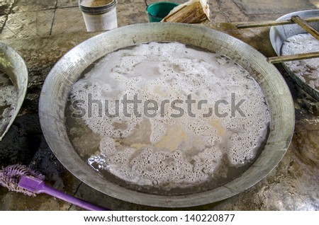 Coconut. (Cocos nucifera Linn.) Fresh coconut simmer with sugar on low heat to start boiling the eggs float.