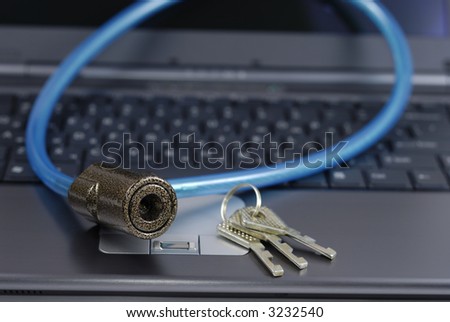 Padlock with bunch of keys over laptop keyboard