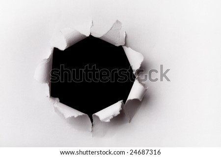 Closeup of a dark hole on white paper