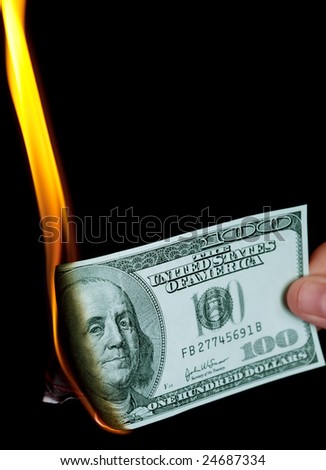Burning one hundred dollars bank-note with portrait of Benjamin Franklin