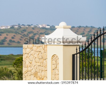 The post of a gate way to a villa in Spain by a river