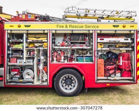 The side view of equipment packed neatly inside a fire engine, fire truck.