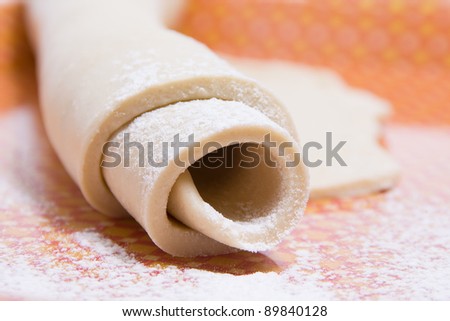 Pastry dough with flour wrapped around ready to work