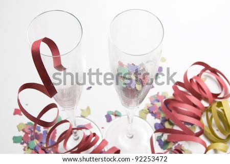 Two empty champagne surrounded by confetti and streamers