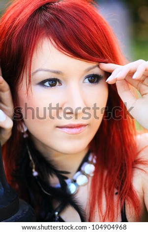 pretty redhead girls closeup portrait removing hair from a face