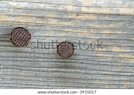 old wooden surface with two nail-heads