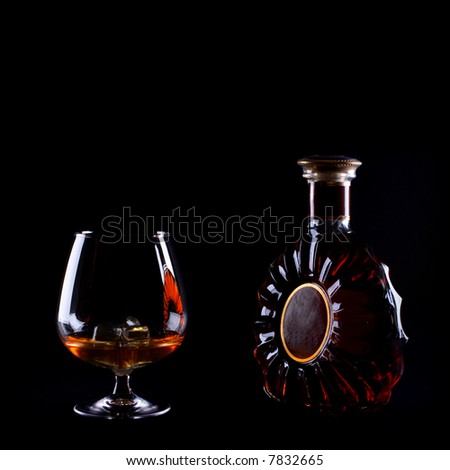 classic cognac bottle with filled glass