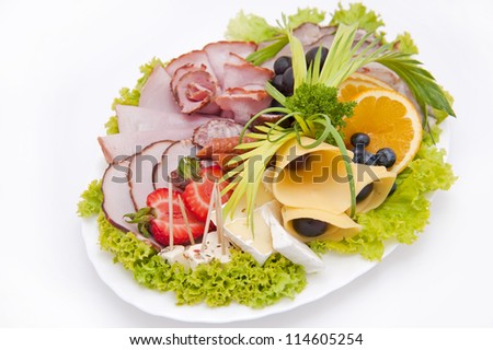 Pieces of delicious smoked meat on a plate isolated on white background.