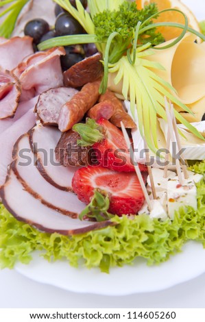 Pieces of delicious smoked meat on a plate isolated on white background.