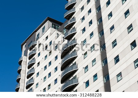 Modern multi-storey residential building with balconies.