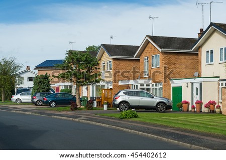 Suburban residential street with modern brick houses.