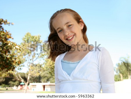 stock photo Smiling preteen pretty girl at the park