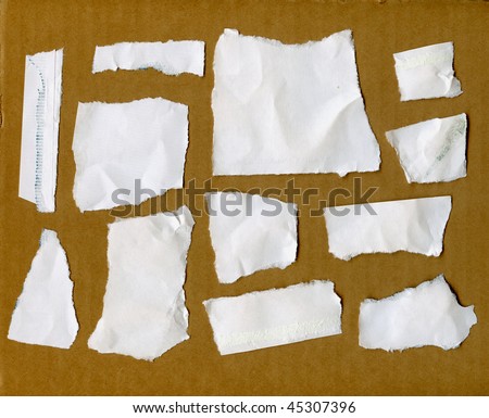 Torn Paper Scraps On Cardboard Wall
