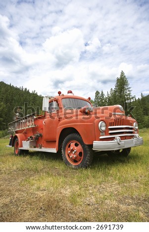 Low angle view of old fire truck in field.