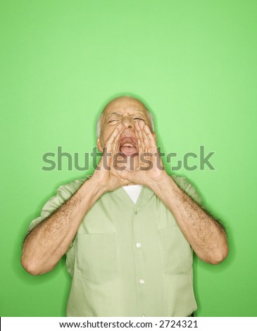 Caucasian mature adult male with hands to mouth yelling.