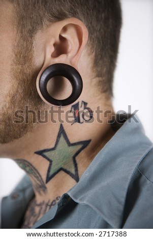 stock photo : Caucasian mid-adult man with tattoos and piercings.