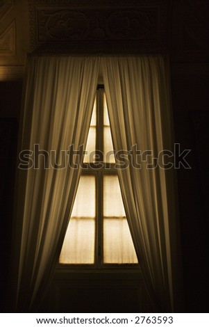Dimly lit window with drapes in the Vatican Museum, Rome, Italy.