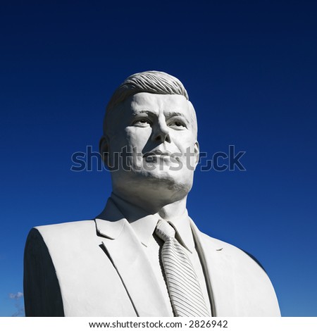 Bust of John F. Kennedy sculpture against blue sky in President\'s Park, Black Hills, South Dakota