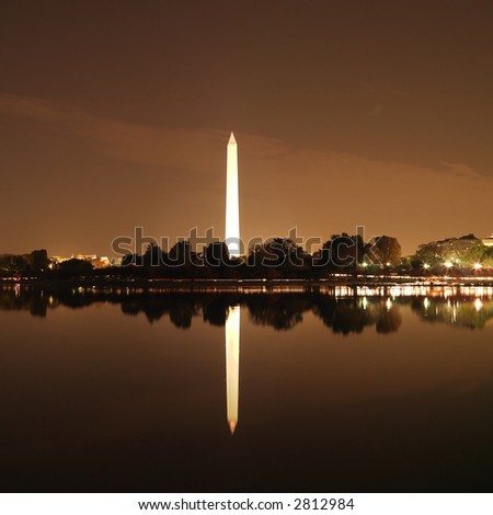 Washington Monument reflected in water at night in Washington, D.C., USA.