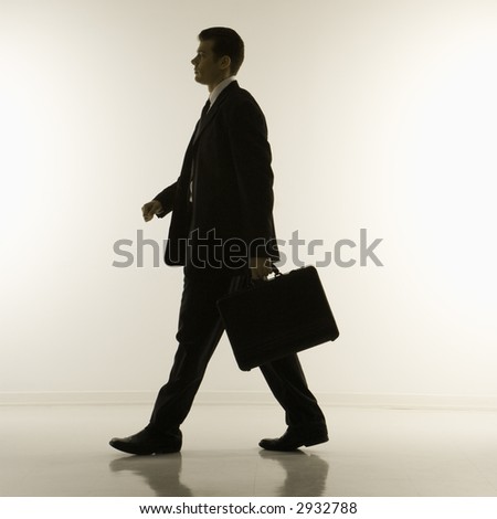 stock photo : Silhouette of mid-adult Caucasian businessman walking and 