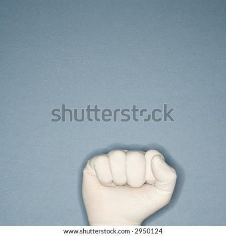 Fist wearing white rubber glove.