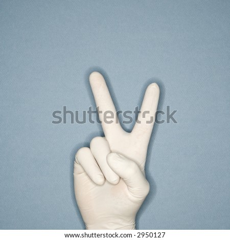 Hand wearing white rubber glove making a gesture meaning peace.