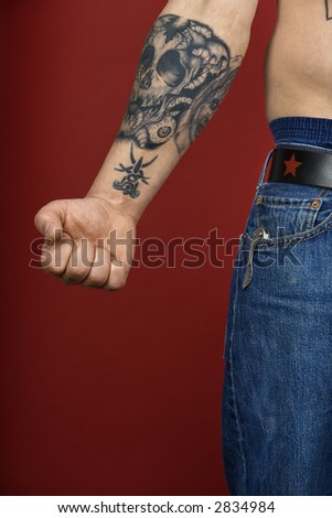 Caucasian mid-adult man's arm with tattoo.