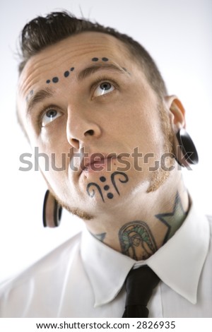 stock photo : Caucasian mid-adult man with tattoos and piercings.