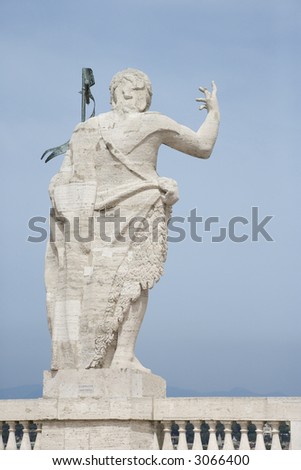 Back view of Roman statue with blue sky in Rome, Italy.