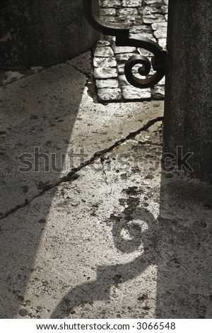 Shadow casted on ground from iron gate in Saint Peter\'s Square, Vatican City, Italy.