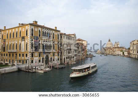 Buildings and cruise boat on canal in Venice, Italy.