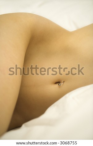 stock photo : Nude Caucasian female body with pierced belly button.
