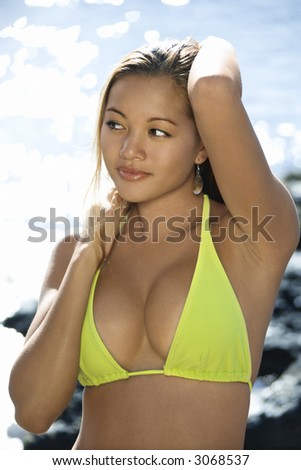 Young adult Asian Filipino female in bikini on beach sexy woman in bikini in Maui Hawaii.