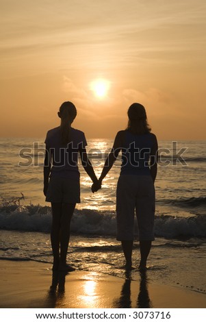 Holding Hands In Sunset. on beach at sunset holding