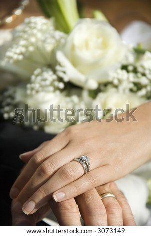 stock photo Caucasian midadult male and female hands with wedding rings