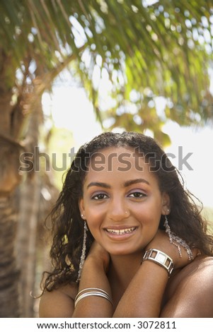 Young-adult Black female smiling and making eye contact.